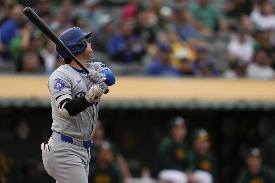 Dodgers' Shohei Ohtani watches Oakland center fielder JJ Bleday catch his fly ball on Friday