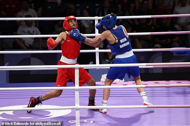 She defeated 23-year-old Hungarian Anna Luca Hamori after spending the past 48 hours, since her first fight in Paris, at the centre of accusations that she was a man.