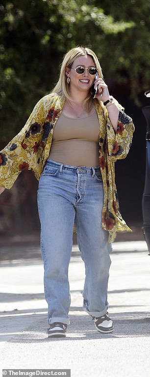 Duff, who gave birth to daughter Townes in May, kept warm from the bright Los Angeles sun in a sheer jacket in shades of gold, red, charcoal and cream.