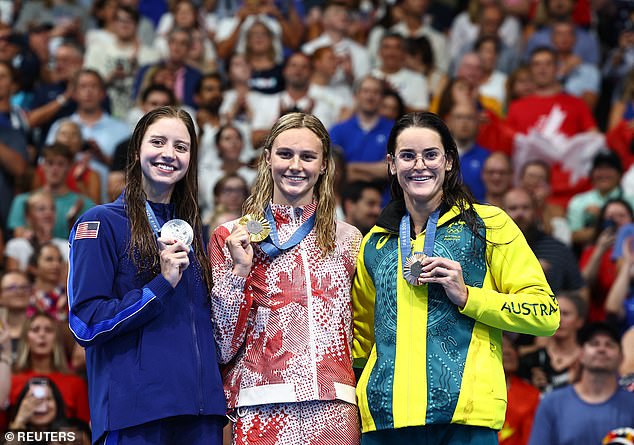 Canadian superstar Summer McIntosh (centre) took gold, while American Kate Douglass (left) won silver, but the judges took away third place from fellow American Alex Walsh.