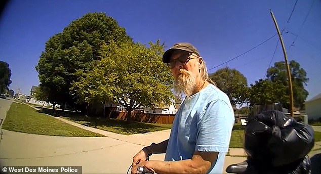 The video shows the bearded fugitive identifying himself as 'Gregory Stallins' and telling the officer he is a homeless man who has lived in Iowa since 1991.