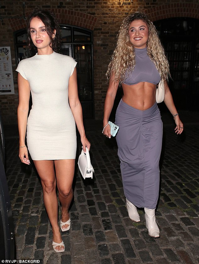 Meanwhile, Antigoni Buxton showed off her toned tummy in a grey crop top and matching low-rise maxi skirt as she arrived with a friend.