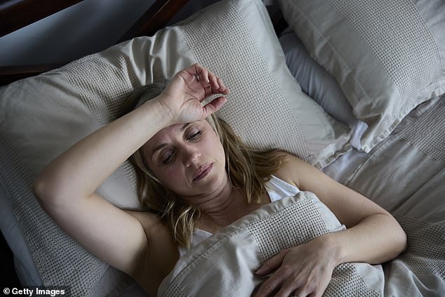 Mature menopausal woman suffering from insomnia in bed at home