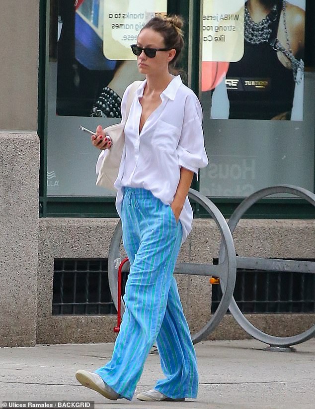 To run her errands, the 40-year-old Don't Worry Darling director donned a loose white button-down shirt and blue drawstring pants.