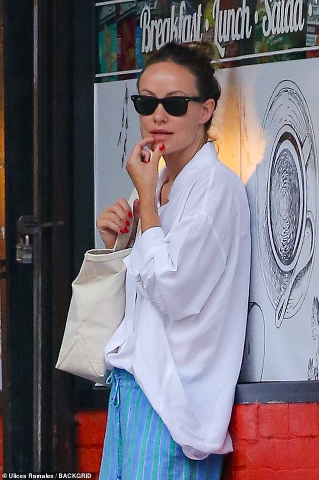 The makeup-free star looked flawless in black Ray-Ban sunglasses and her brunette hair styled in a high bun.