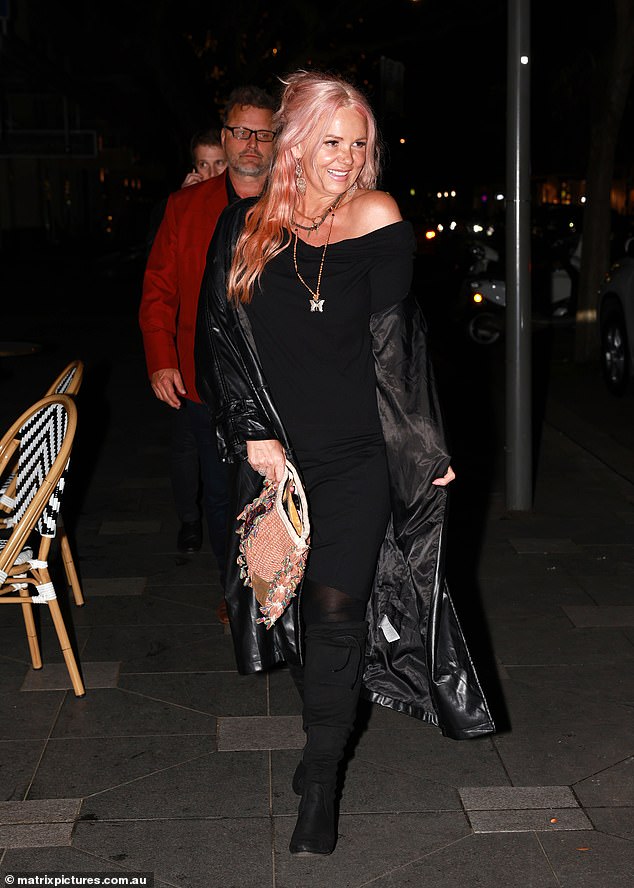 Andrea Thompson also dressed to impress in an off-the-shoulder black dress and long leather coat.