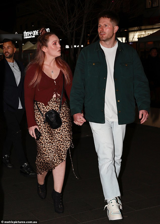 Melissa Rawson flaunted her figure in a burgundy crop top and patterned skirt as she arrived with husband Bryce Ruthven.