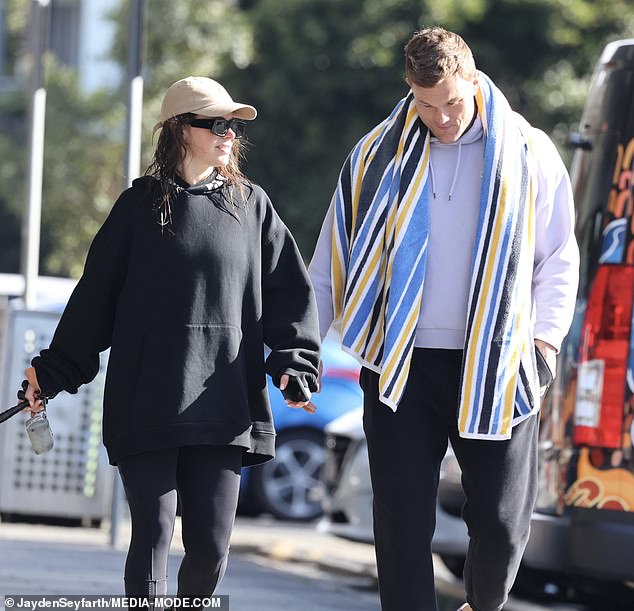 She completed her ensemble with a pair of dark-colored sneakers, sunglasses and a baseball cap, letting her brunette locks flow freely down to her shoulders.