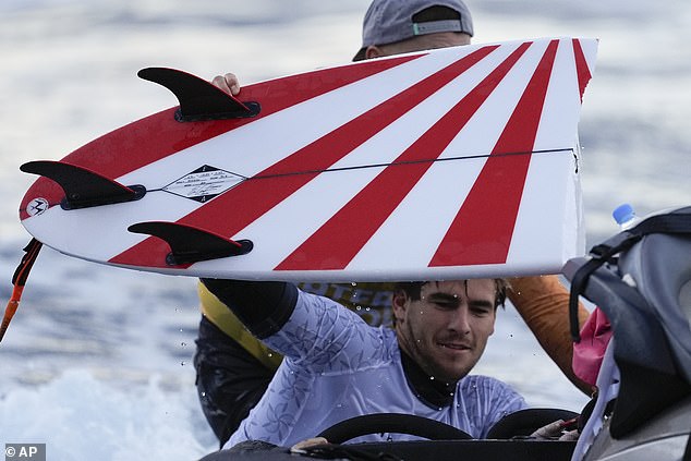 Robinson (pictured after breaking one of his boards) inadvertently offended South Koreans with his red rising sun design.