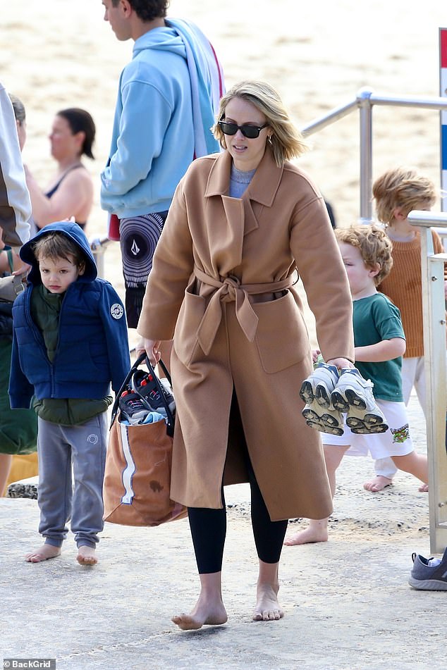 The couple looked relaxed and happy, watching their sons Oscar and Henry playing nearby.