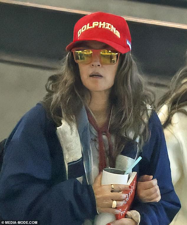 Drew appeared to be makeup-free for her long flight back to the US and donned reflective designer sunglasses.