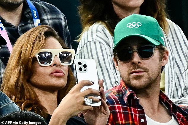 Ryan sported a green Olympics baseball cap, while Eva sported a pair of thick white sunglasses as she snapped a photo during the event.