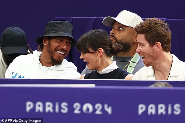 The Mercedes driver appeared in good spirits as he chatted to the American actress and former snowboarder while watching the men's individual foil competition.