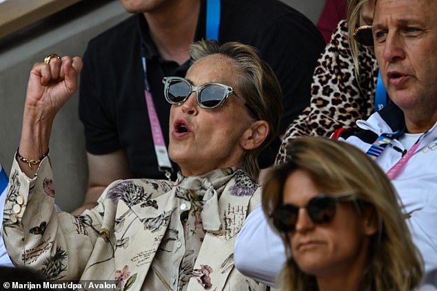 The 66-year-old was seen cheering and raising his fist during the tense match between Spain and Serbia.