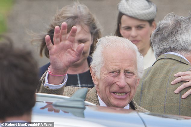 Charles is seen waving to the crowd after leaving the Sunday service.