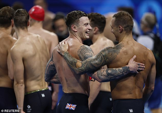 Peaty chats with American swimmer Caeleb Dressel today after what could be his last race for the British team