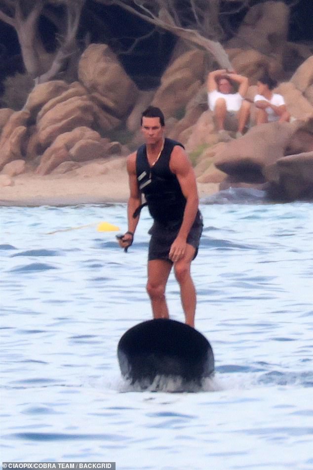 He donned a pair of black shorts and a life jacket as he tried his luck at surfing.