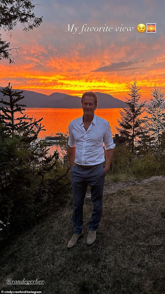 Another snap shows the Casamigos co-founder standing in front of the lake against a stunning orange and yellow sunset. 