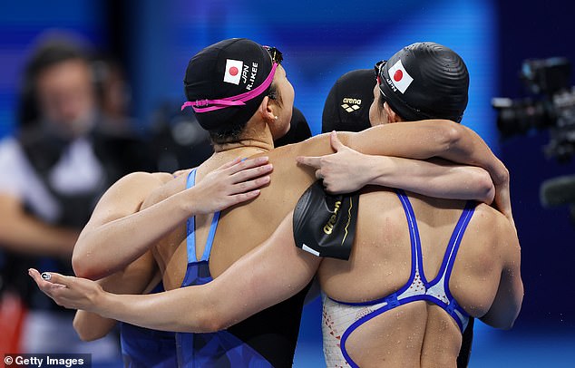 Rio Sharai, Satomi Suzuki, Mizuki Hirai and Rikako Ikee of Team Japan hug after competing in the final of the women's 4x100m medley relay