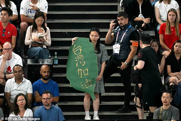 Security also acted when this woman held up a sign depicting the shape of the island of Taiwan with a phrase that read: 