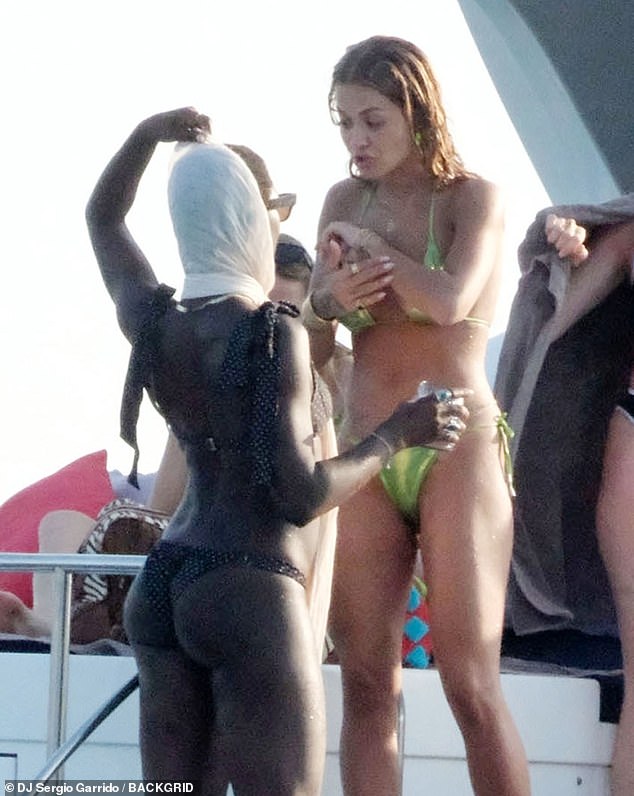 The 37-year-old actress showed off her stunning figure in a black bikini as she was seen sipping a cocktail and chatting with friends aboard the luxury ship, including Rita Ora.