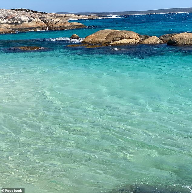 The clear water at Little Beach fades from a soft turquoise to a deep blue.