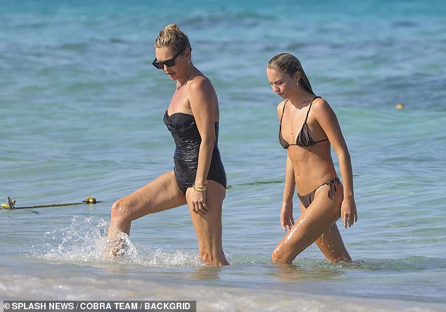 The 50-year-old model belied her age in a striking £125 black Gottex bandeau swimsuit that accentuated her supermodel physique as she relaxed on the beach.