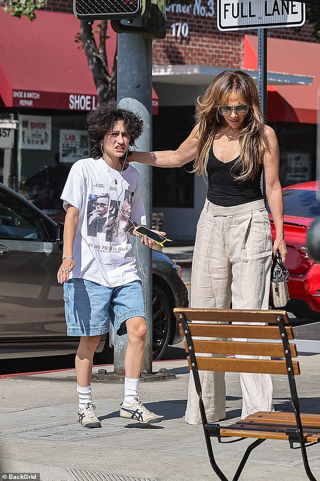 The star looked sombre as she stepped out with 16-year-old Emme, dressed in a low-cut black top and high-waisted cream trousers, after returning to Los Angeles from an extended stay in the Hamptons.