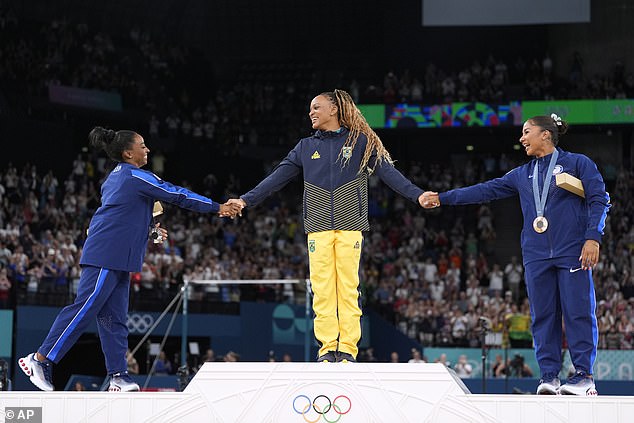 The trio held hands as they celebrated their success on the final day of gymnastics in Paris.