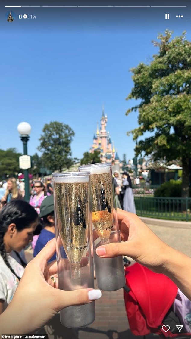 Paraguayan swimmer Luana Alonso clinking champagne glasses at Euro Disneyland