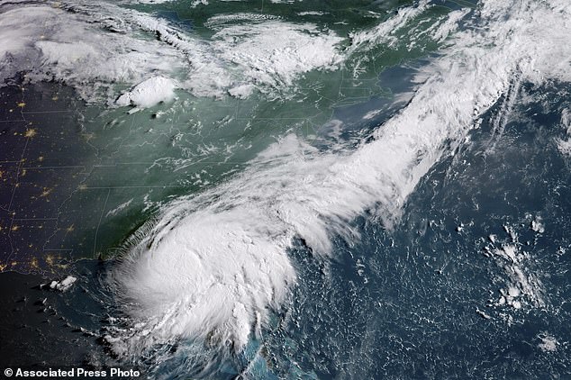 This GOES-16 GeoColor satellite image taken at 8:16 a.m. EDT and provided by the National Oceanic and Atmospheric Administration (NOAA) shows Hurricane Debby, bottom left, a Category 1 storm over northern Florida, on Monday, Aug. 5, 2024.