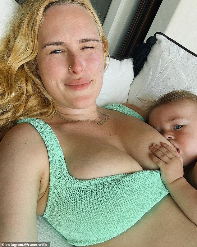 In the first photo in the slideshow, the doting mom is wearing a green top and naturally breastfeeding her daughter. 