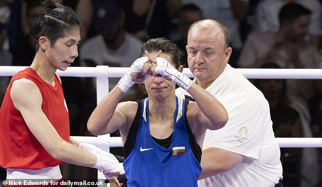 Staneva made an X sign in the ring, presumably to suggest that she was all woman and Lin was not.