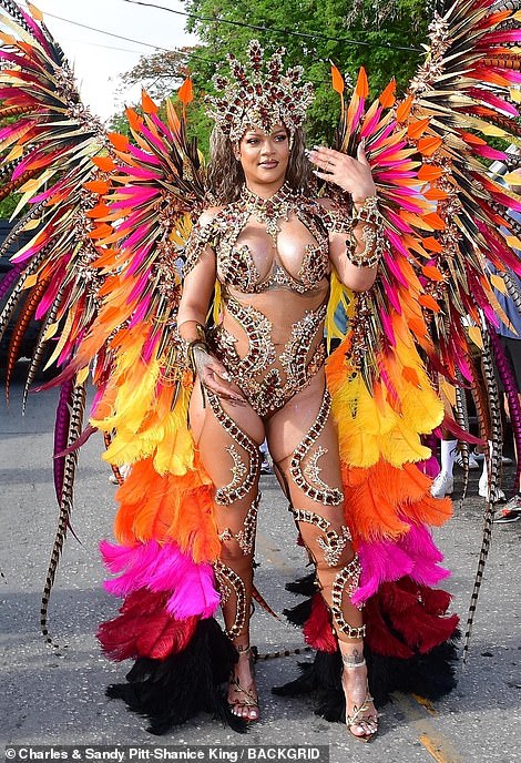 The 36-year-old singer put on a majestic display at the Crop Over Carnival in a striking outfit covered in long, colourful feathers that flowed majestically from her fit frame.