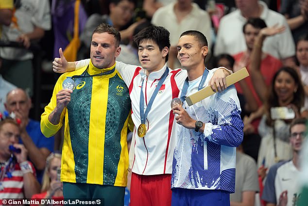 The Chinese star comfortably beat Australia's Kyle Chalmers (left) and Romania's David Popovici (right) in the 100m freestyle final at the Games.