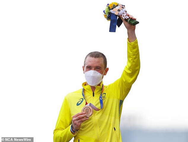 Dennis shows off his bronze medal at the Tokyo Olympics. Photo: Tim de Waele/Getty Images