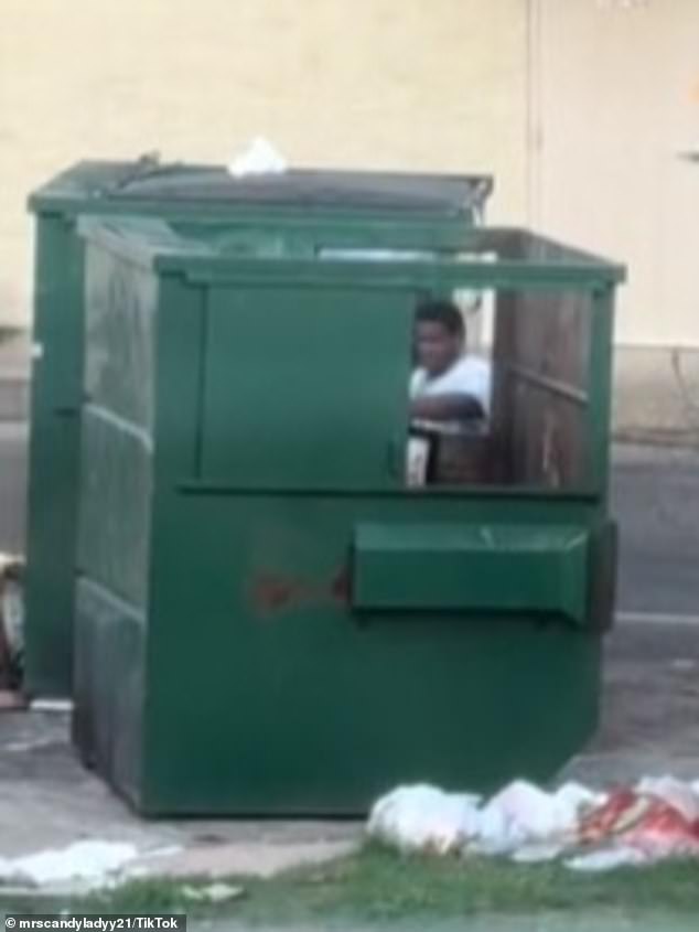 On TikTok, the alleged USPS worker can be seen throwing containers full of mail into the dumpster.