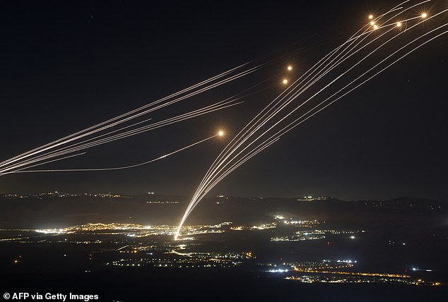 Footage shows the Iron Dome system firing defensive missiles (pictured) to intercept the bombardment amid ongoing clashes between Israeli troops and Lebanese Hezbollah fighters.