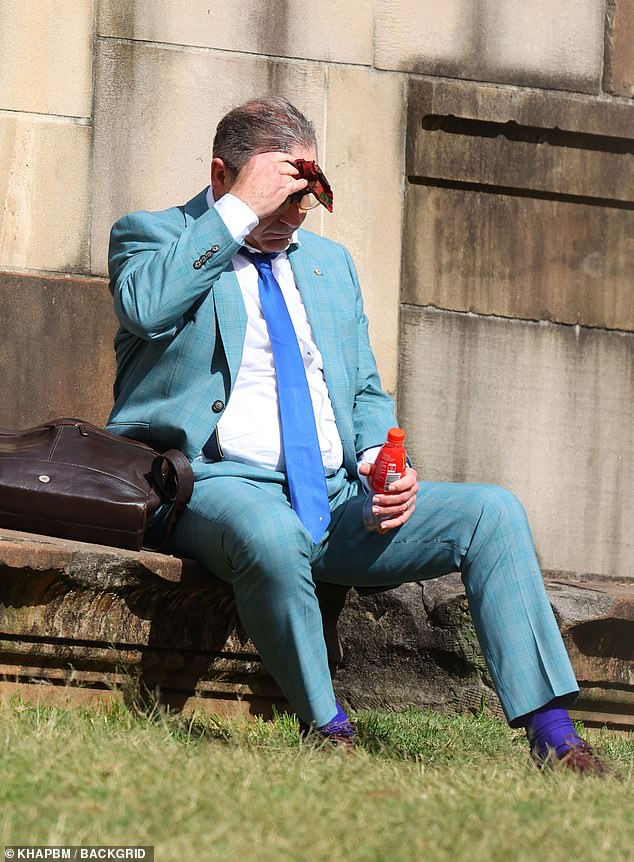 The former Chase Australia presenter, wearing a turquoise checked suit paired with a tie and socks in varying shades of blue, wiped his sweaty forehead with a handkerchief.