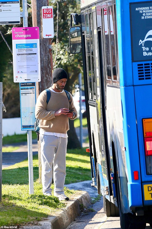 The actor looked like a regular passenger as he waited, wearing a camel-coloured jumper over a white shirt. He added a pair of baggy grey tracksuit bottoms and black and white trainers, as well as a black beanie.