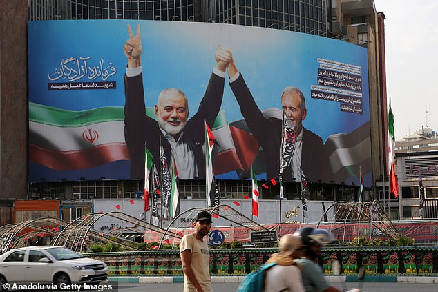 Poster of Iranian President Masoud Pezeshkian with Hamas Political Bureau chief Ismail Haniyeh at the inauguration ceremony, hanging on Veliasr Street in Tehran, Iran