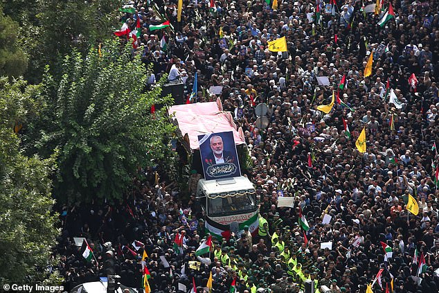 People gather during a funeral procession for Ismail Haniyeh, the Hamas political leader and his bodyguard who were killed in an assassination in Tehran, Iran.