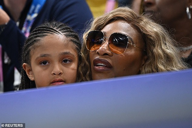 Serena cradled Olympia, whom she shares with husband Alexis Ohanian, as they enjoyed the game.