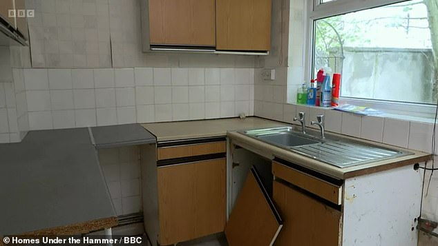 The home's original kitchen had loose tiles and a cabinet door completely removed from its hinges.