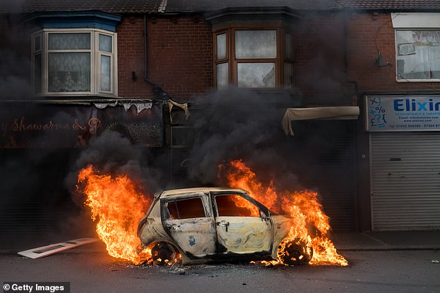 A car burns on Parliament Road after being set alight by far-right activists during a demonstration in Middlesbrough on August 4, 2024