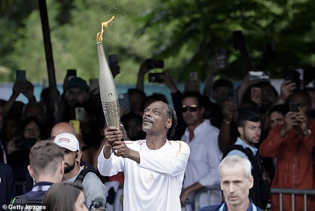 Snoop Dogg carried the Olympic torch in Paris ahead of the opening ceremony on Friday, as people joked that he looked like a joint.