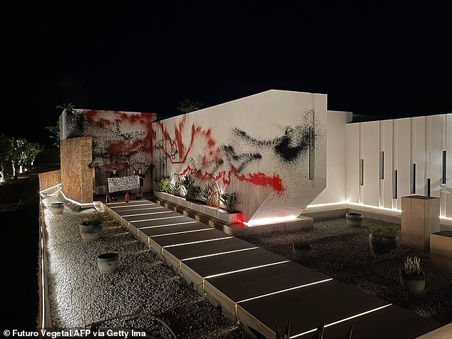 Climate group Futuro Vegetal sprayed the white facade of the building with red and black paint.