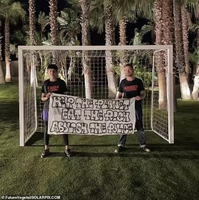 Two members of the group pose in front of the footballer's goal in his back garden.