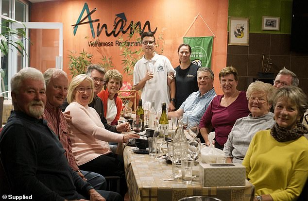 The family has been working mostly seven days a week to slowly pay off the restaurant, which they did last year (pictured, center, Justin and Hue with customers).