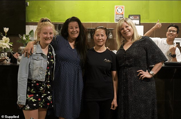 The family were told their sponsor made a mistake by hiring an employee with an expired visa, which meant they could no longer nominate workers (pictured, second from right, chef and owner of Vietnamese restaurant Anam, Hua Nguyen, 54, with customers and Justin in background)